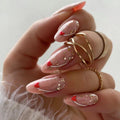 Close-up of a hand with pink and gold glittery nail art on a neutral background, Obroi