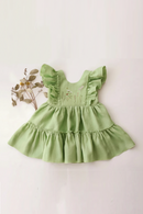 Green dress with floral embroidery on a beige background, Obroi