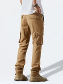 Person wearing tan cargo pants on a white background, Obroi