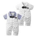 Two baby short-sleeve romper outfits shown on a plain white background. Each romper is white with a light blue striped collar and a dark gray bow tie, styled like a formal suit, Obroi
