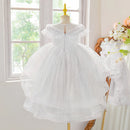White lace dress on a mannequin in a bright room with a window, Obroi