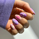 Hand with pink and purple gradient nails on a neutral background, Obroi
