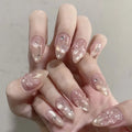 Hand with pink and gold glittery nail design on a neutral background, Obroi