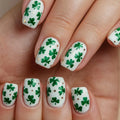 Nails with green shamrock designs on a white background, Obroi