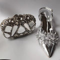 Silver high-heeled shoe with decorative crystal embellishments on a gray background, Obroi