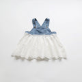 Denim pinafore dress with lace skirt on a white background, Obroi