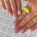Close-up of hands with pink and yellow nail polish on a grid background, Obroi