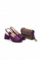 Purple high-heeled shoes with a matching handbag on a white background, Obroi