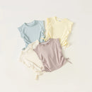 Three baby rompers in pastel colors on a light background, Obroi