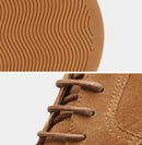Close-up of brown shoe with textured sole and laces on a white background, Obroi