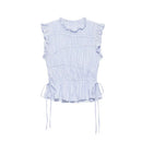 A sleeveless light blue and white vertically striped smocked blouse with ruffled shoulders, a ruffled collar, and side drawstrings at the peplum hem, shown against a plain white background, Obroi