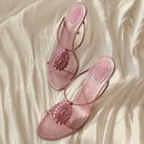 Pink sandals with embellishments on a soft, light fabric background, Obroi