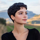 Woman with short dark hair in a natural setting with mountains and greenery, Obroi