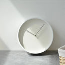 Modern wall clock with a minimalist design on a plain wall, Obroi