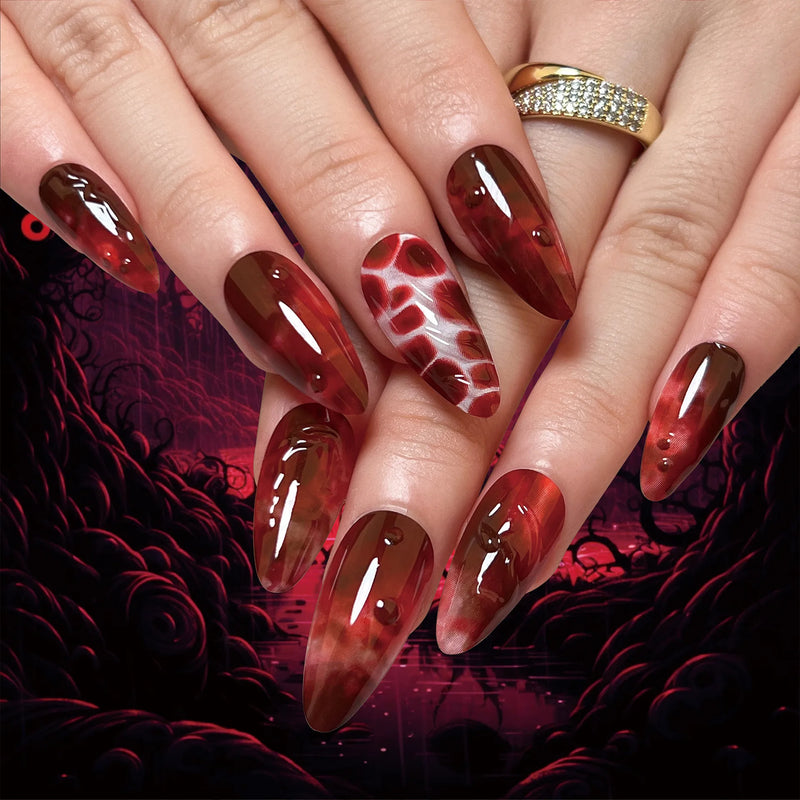 Obroi Close-up of hands with red and brown nail polish on a dark background