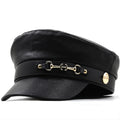 Black leather cap with gold accents on a white background, Obroi