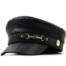 Black leather cap with gold accents on a white background, Obroi