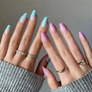 Close-up of hands with pastel gradient nail polish and rings on a neutral background, Obroi