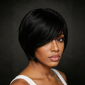 A woman with a short, straight black wig styled with a side-swept bang, shown in a close-up portrait against a dark gray background, Obroi