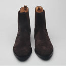 Pair of brown suede ankle boots on a light gray background with 'Obroi' branding.