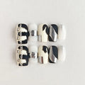 Set of black and white nail art designs on a light gray background, Obroi