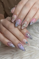 Close-up of hands with decorative nail art on a soft background, Obroi