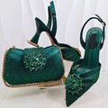 Green high-heeled shoes and matching handbag with embellishments on a white background, Obroi