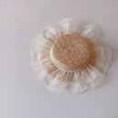 Round woven object with sheer on a light gray background, Obroi