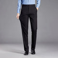 Person wearing black dress pants with a gray background, Obroi