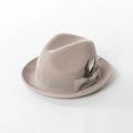 Beige fedora hat with a feather on a white background, Obroi