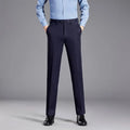 Person wearing navy pants and a light blue shirt on a gray background, Obroi