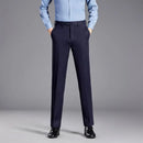 Person wearing navy pants and a light blue shirt on a gray background, Obroi