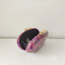 Multicolored clutch bag with gold accents on a white surface, Obroi
