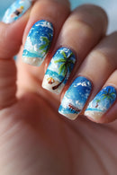 Nails with beach-themed design featuring palm trees, sand, and ocean waves, Obroi