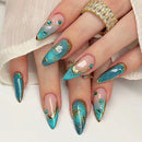 Nails with blue and gold design on a white background, Obroi