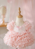 Pink ruffled dress on a mannequin against a soft pink background, Obroi