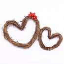 Decorative heart made of twigs with red berries on a white background, Obroi