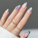 Hand with decorative nails and a gold ring on a neutral background, Obroi
