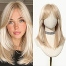 Blonde wig on a mannequin head next to a woman with similar blonde hair, Obroi