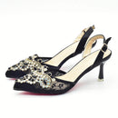 Black high-heeled shoes with decorative embellishments on a white background, Obroi