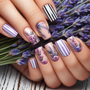 Nails with floral and striped designs held over a lavender flower bouquet, Obroi