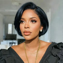 Woman with styled hair wearing a black top and gold necklace indoors, Obroi