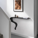 Modern black console table against a white wall with a framed artwork above it, Obroi