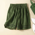 Green shorts with lace trim on a beige background, Obroi