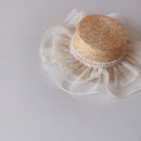 Straw hat with pearl embellishments on a light gray background, Obroi