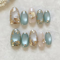 Set of nail designs with gold leaf and pearl accents on a light background, Obroi