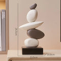 Stack of stones on a wooden base with measurements, placed on a shelf, Obroi
