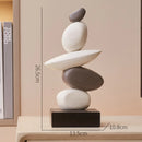 Stack of stones on a wooden base with measurements, placed on a shelf, Obroi