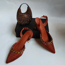 Brown embellished shoes and handbag on a white background, Obroi