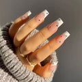 Obroi Hand with stylish nails and a gold ring on a neutral background